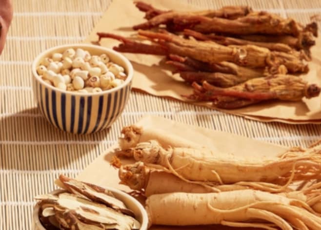 Healthy meal with vegetables, fish, grains, and ginseng tea